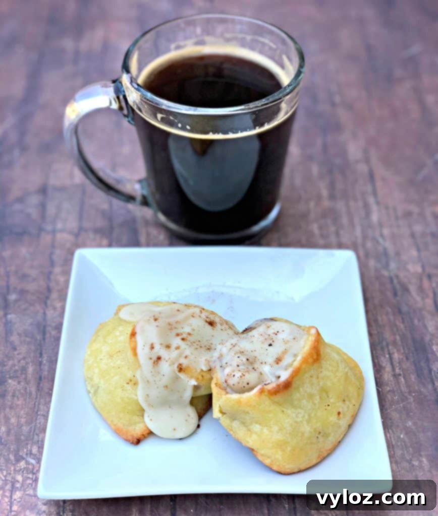 keto fathead cinnamon rolls on a white plate with coffee
