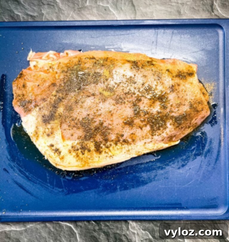 Instant Pot Tender Turkey Breast 5 Raw turkey breast placed in Instant Pot with onion and broth.