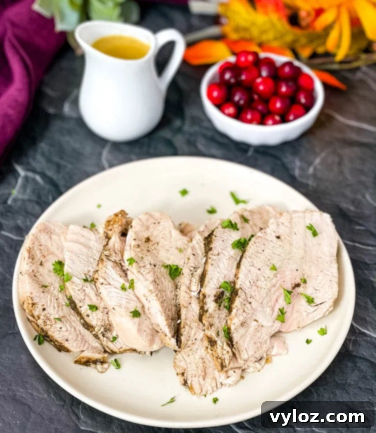 Instant Pot Tender Turkey Breast 7 Two cooked turkey breasts, one whole and one sliced, with gravy on a plate.