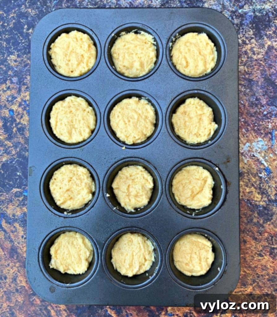 Keto biscuits in a muffin tin before baking