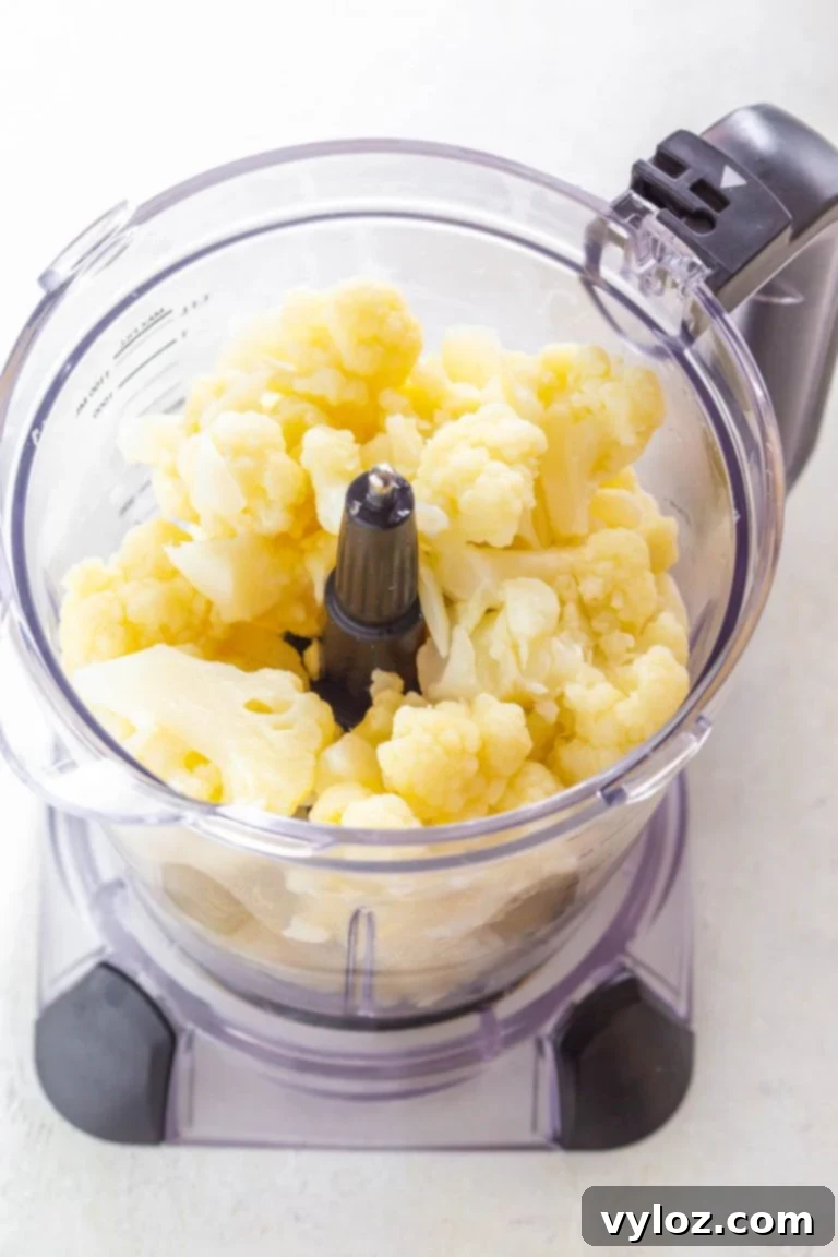 A serving of creamy keto cauliflower mashed potatoes in a white bowl