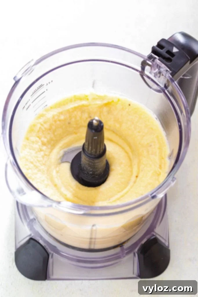 Cauliflower and other ingredients being blended in a high-powered blender