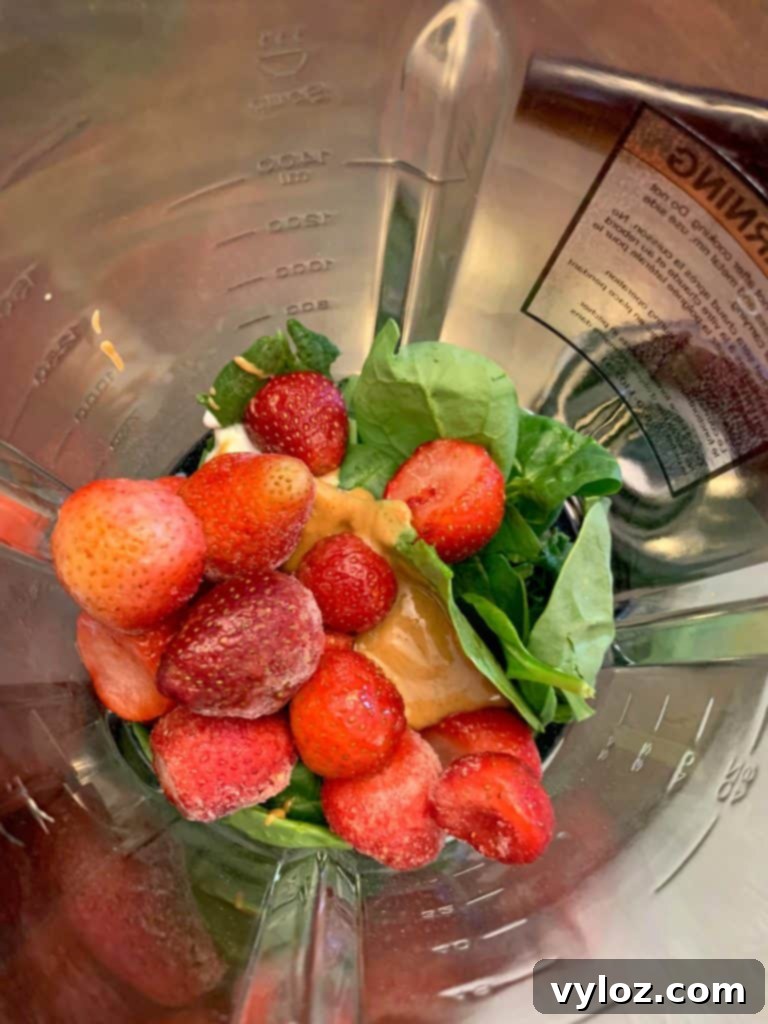 Creamy Strawberry Peanut Butter Delight 4 Fruit and vegetables being added to a high-powered blender