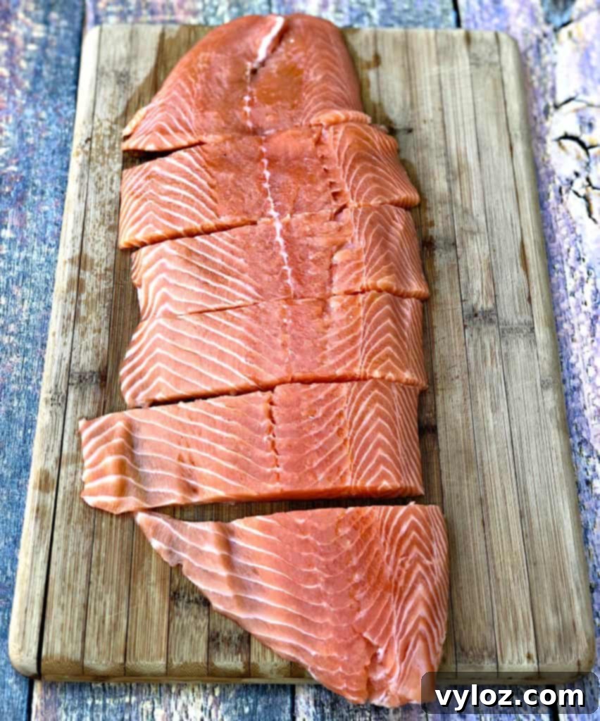 raw salmon sliced on a cutting board