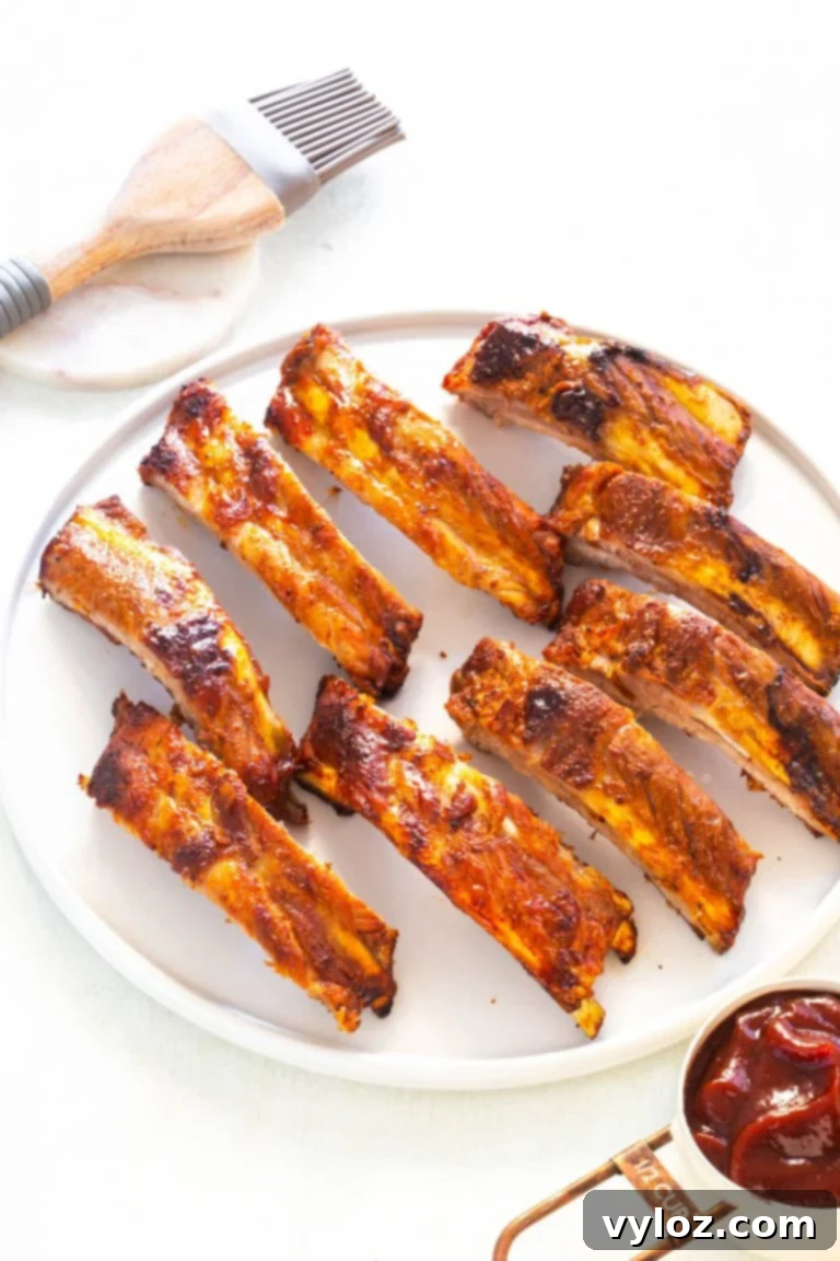 Raw rack of ribs prepared for cooking in an air fryer basket
