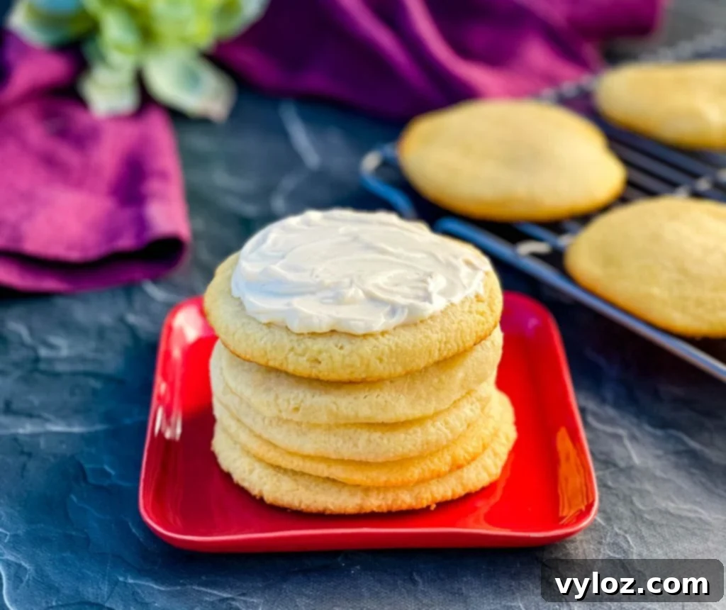 Delicious keto low carb sugar cookies with cream cheese frosting on a festive red plate, perfect for a balanced treat.