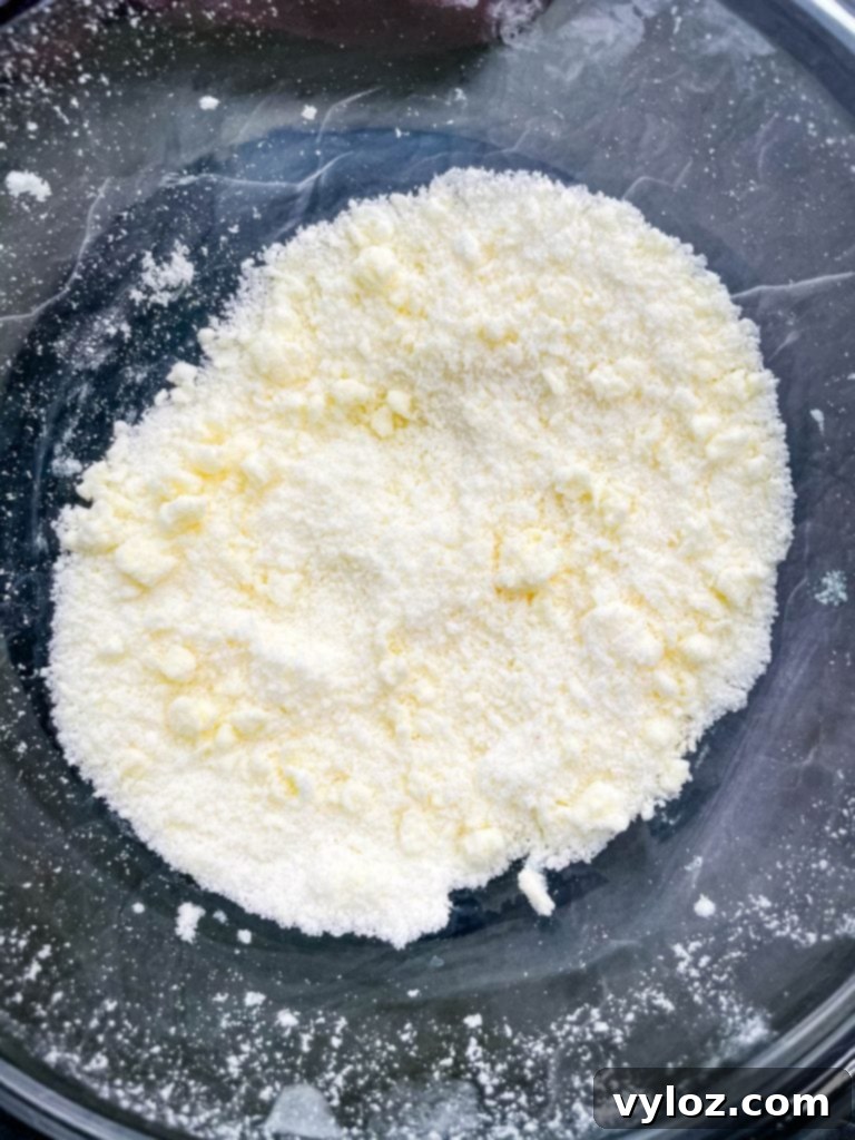 Close-up of shaped keto low carb gluten free sugar cookie dough balls on a baking sheet, ready for the oven.