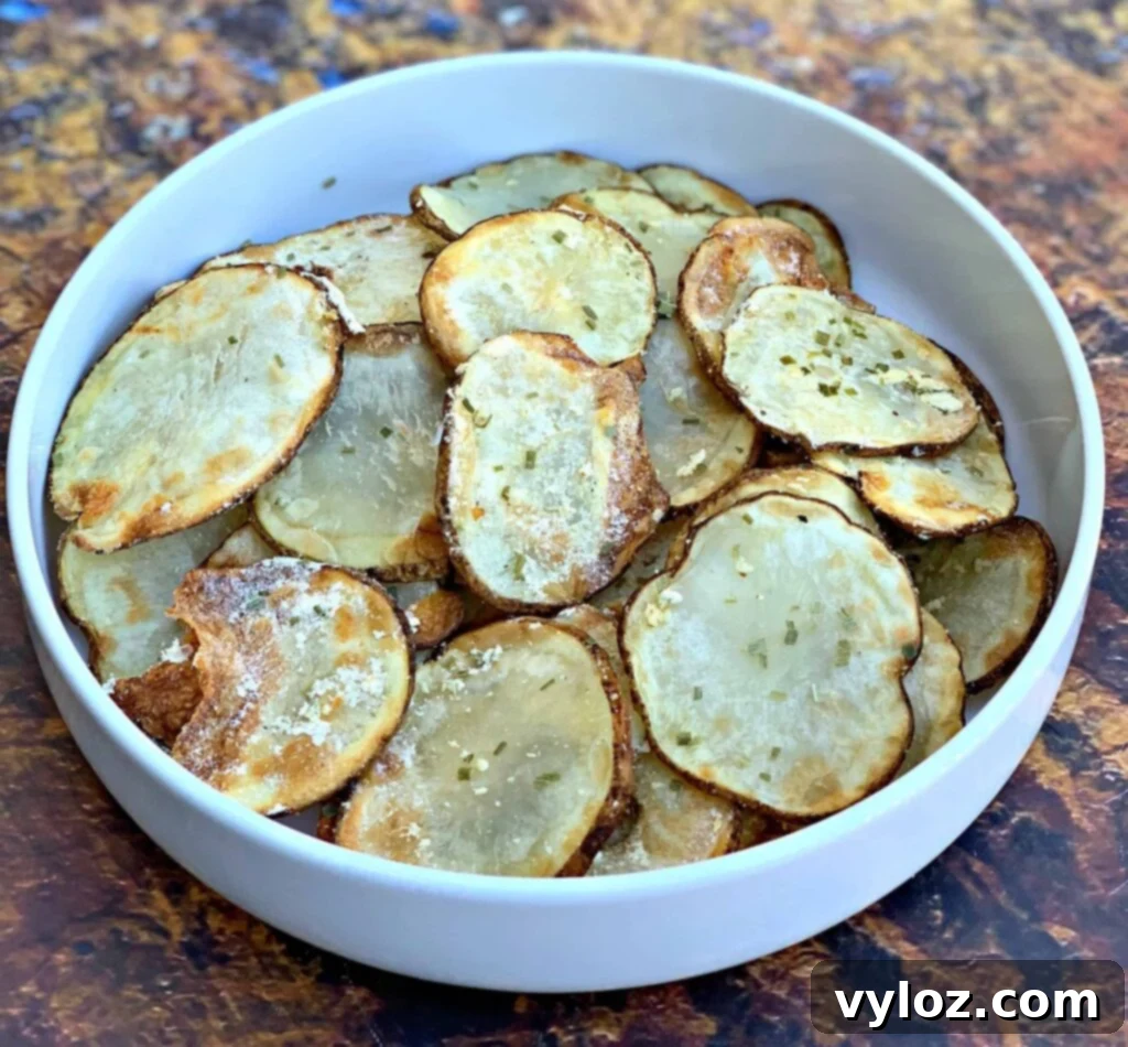 Crispy Air Fryer Homemade Potato Chips 2 Crispy air fryer potato chips in a white bowl, ready to be enjoyed.