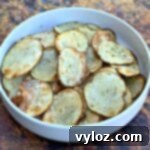 Crispy Air Fryer Homemade Potato Chips 12 Air fryer potato chips in a white bowl, a close-up for the recipe card.