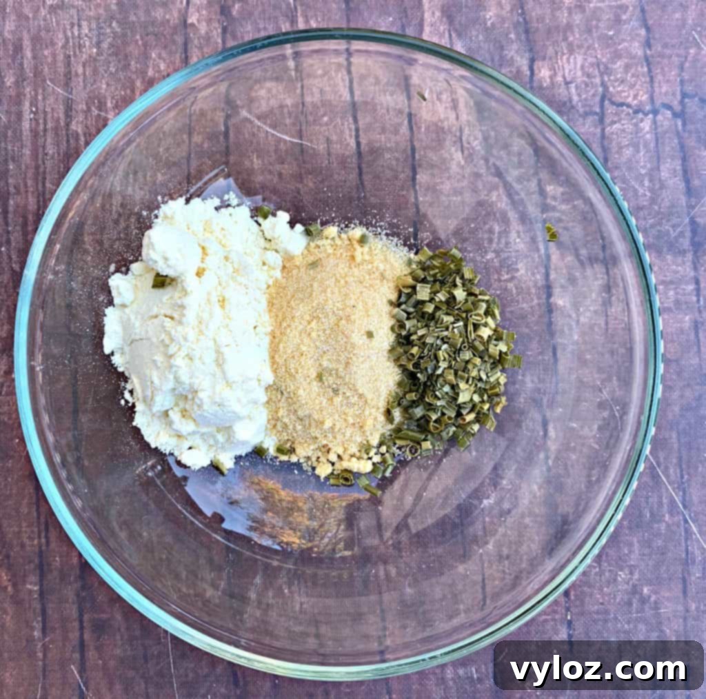 Crispy Air Fryer Homemade Potato Chips 4 A bowl filled with homemade sour cream and onion seasoning blend.