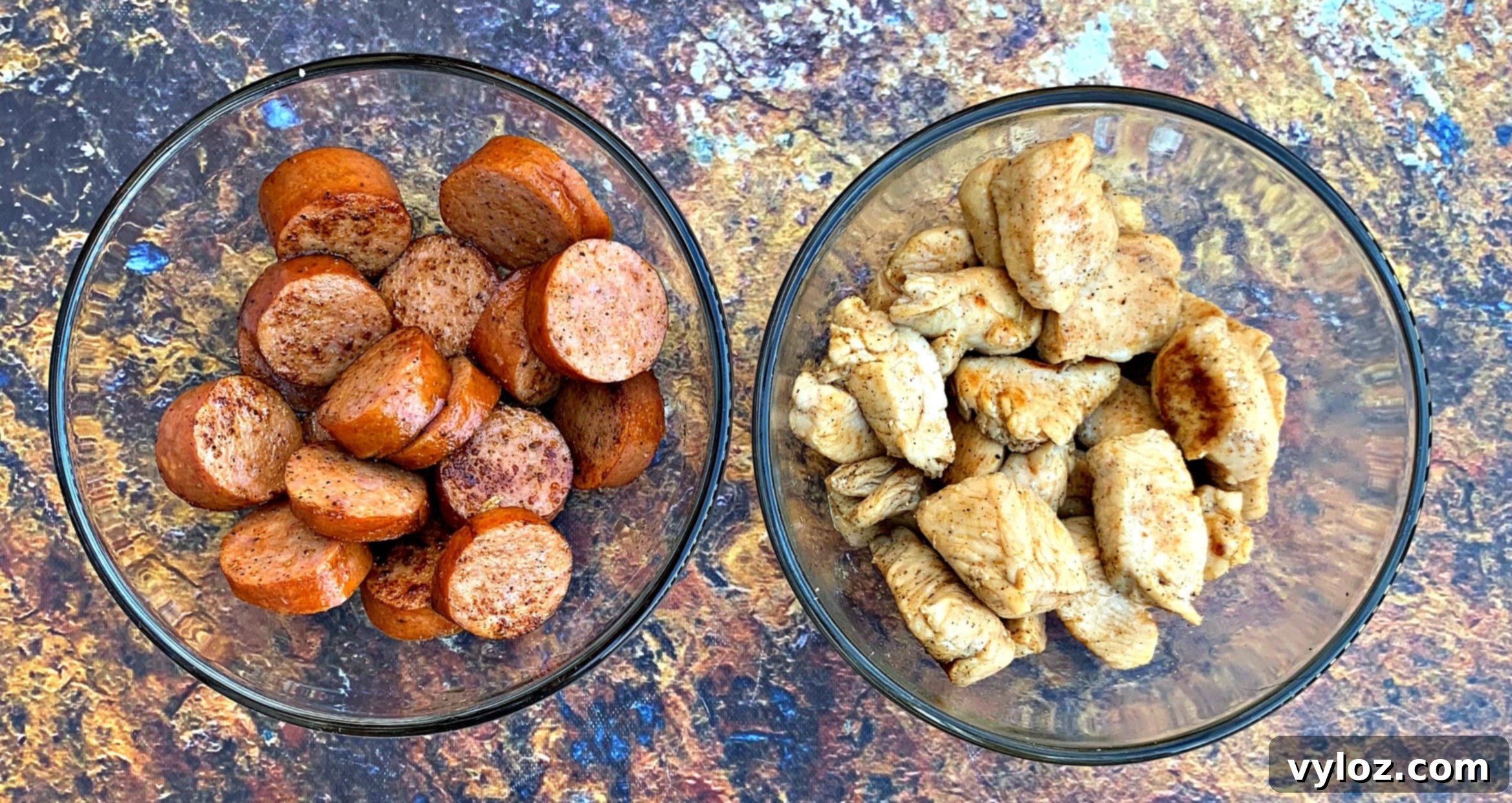 Hearty Cajun Chicken and Sausage Skillet 4 Bowls filled with chopped andouille sausage and diced chicken, ready for the skillet