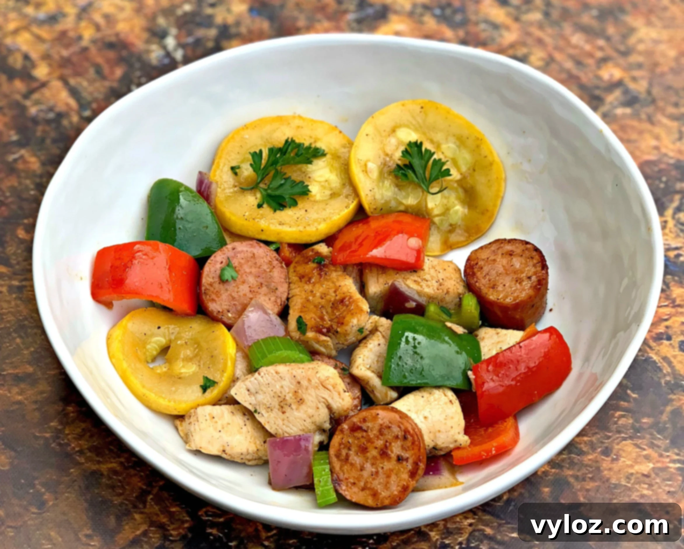 Hearty Cajun Chicken and Sausage Skillet 7 Cajun Chicken and Sausage Skillet served in a white bowl, ready to eat