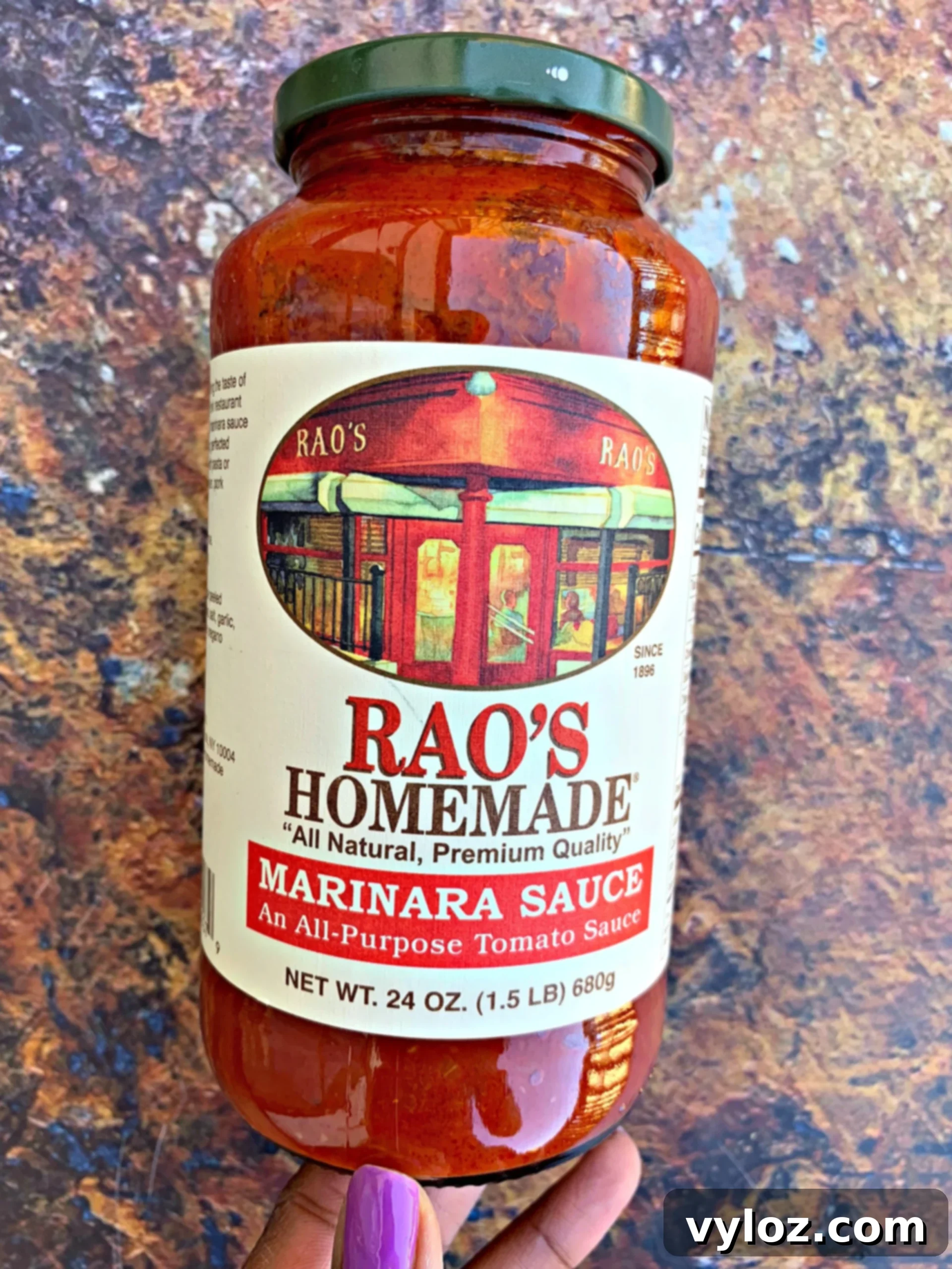 A glass jar of premium Rao's Marinara Sauce, prominently displayed to highlight its quality as a low-carb, all-natural, and delicious ingredient for healthy cooking.