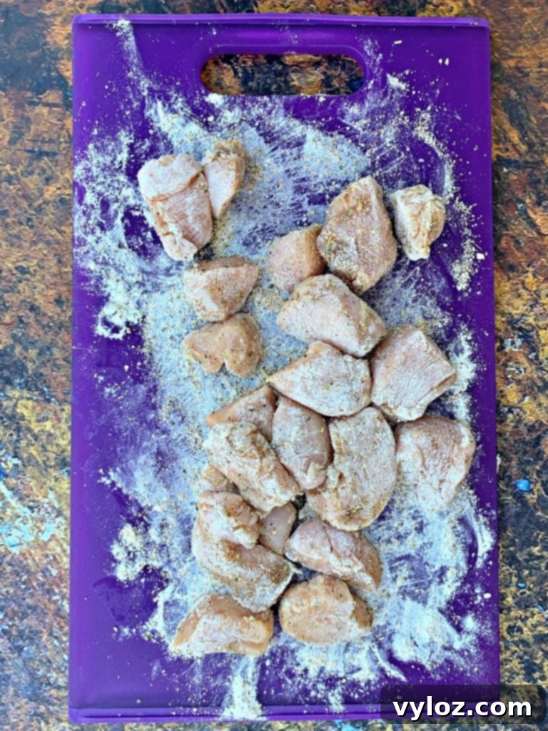 Crispy Air Fryer Chicken Nuggets 3 sliced chicken breasts on a cutting board