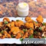 Crispy Air Fryer Buffalo Cauliflower 12 Crispy Air Fryer Buffalo Cauliflower Wings on a white plate with dip