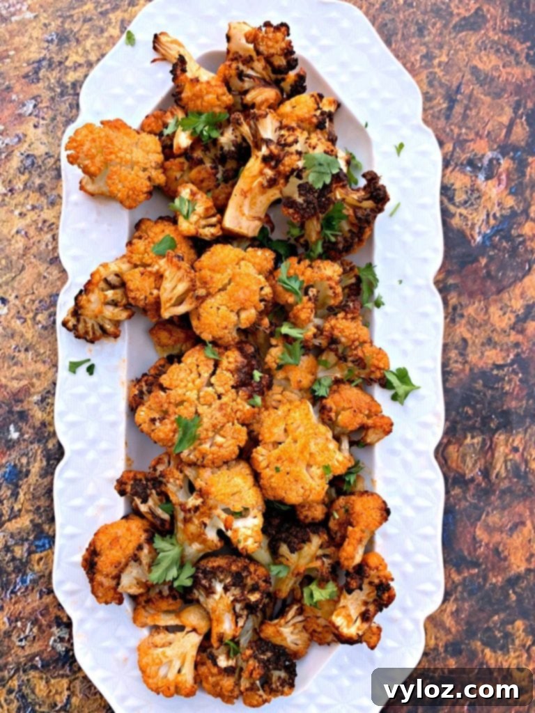 Crispy Air Fryer Buffalo Cauliflower 8 A serving of keto buffalo cauliflower wings on a white plate, ready to be enjoyed