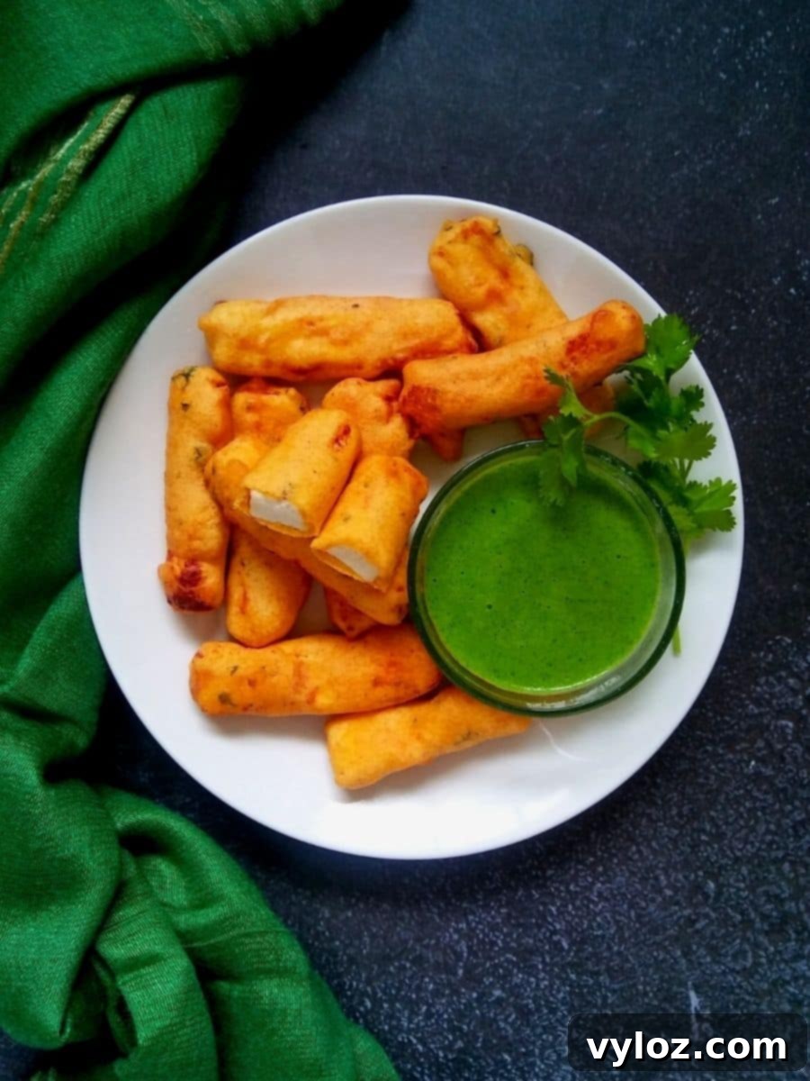Crispy Paneer Pakora Made Easy 3 Platter of Punjabi paneer pakora with a side of green chutney, ready to be served