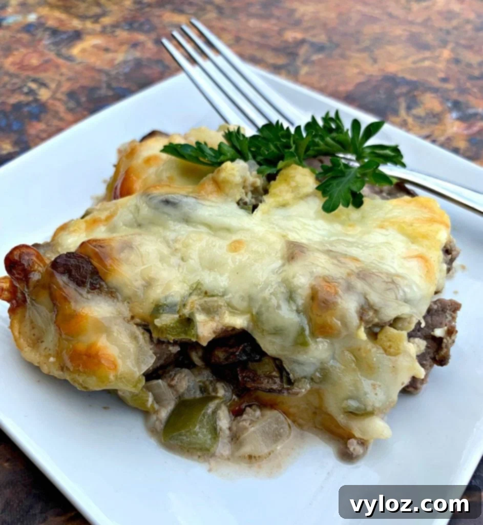 Another perspective of a single serving of Keto Low-Carb Philly Cheesesteak Casserole on a white plate.