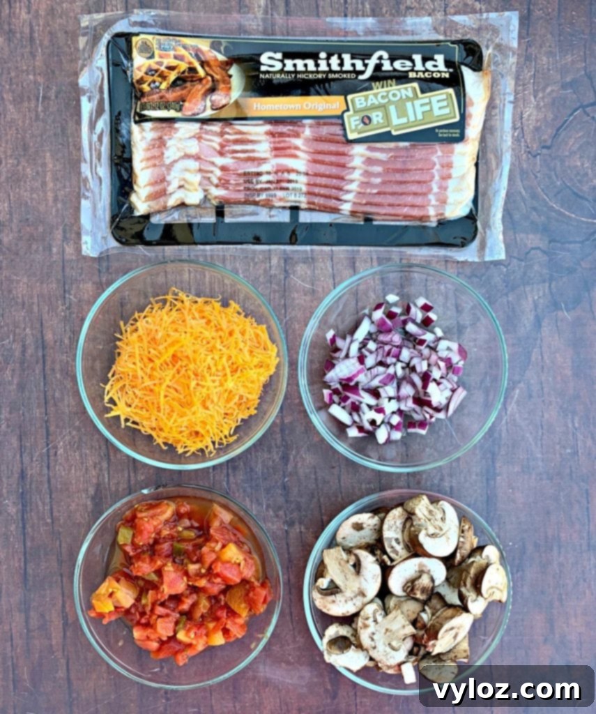 Fresh ingredients laid out for making keto low-carb bacon and mushroom stuffed peppers, including bell peppers, bacon, mushrooms, onions, and cheese.