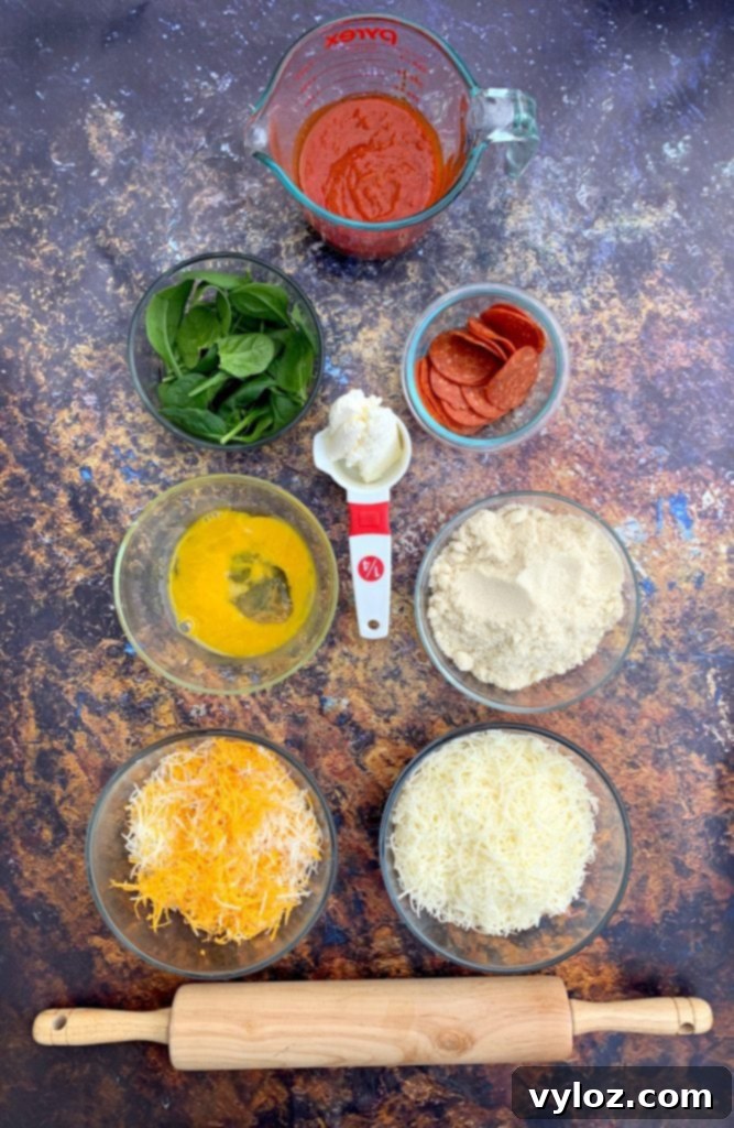 Assortment of fresh ingredients for making keto pepperoni pizza, including various cheeses, almond flour, and vibrant pepperoni slices.