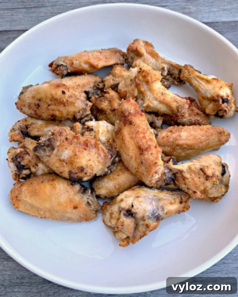 No-Fuss Sticky Honey BBQ Wings 5 Crispy fried chicken wings coated in honey BBQ sauce, served in a white bowl.