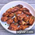 No-Fuss Sticky Honey BBQ Wings 10 air fryer honey bbq chicken wings in a white bowl