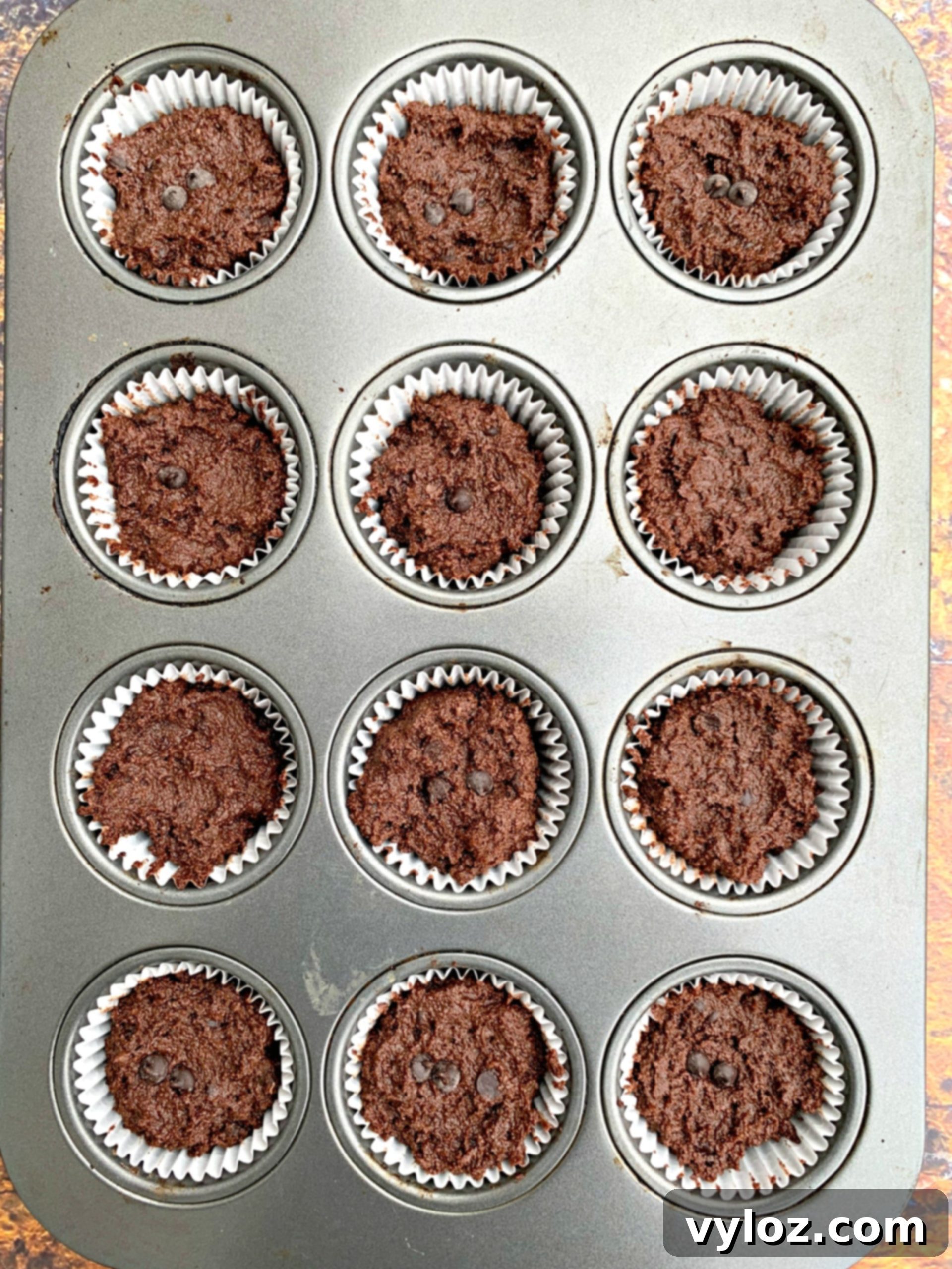 uncooked keto low carb chocolate muffins in a muffin tin