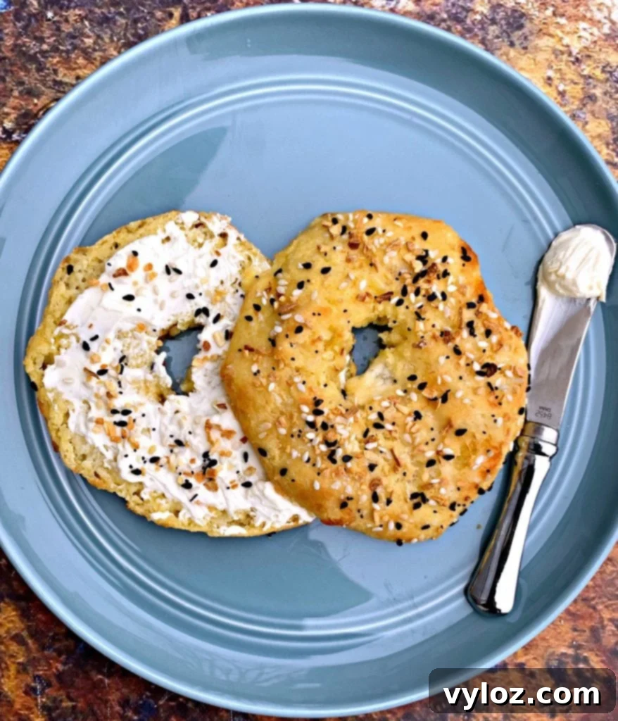 Cooked keto fathead bagels on a blue plate with cream cheese