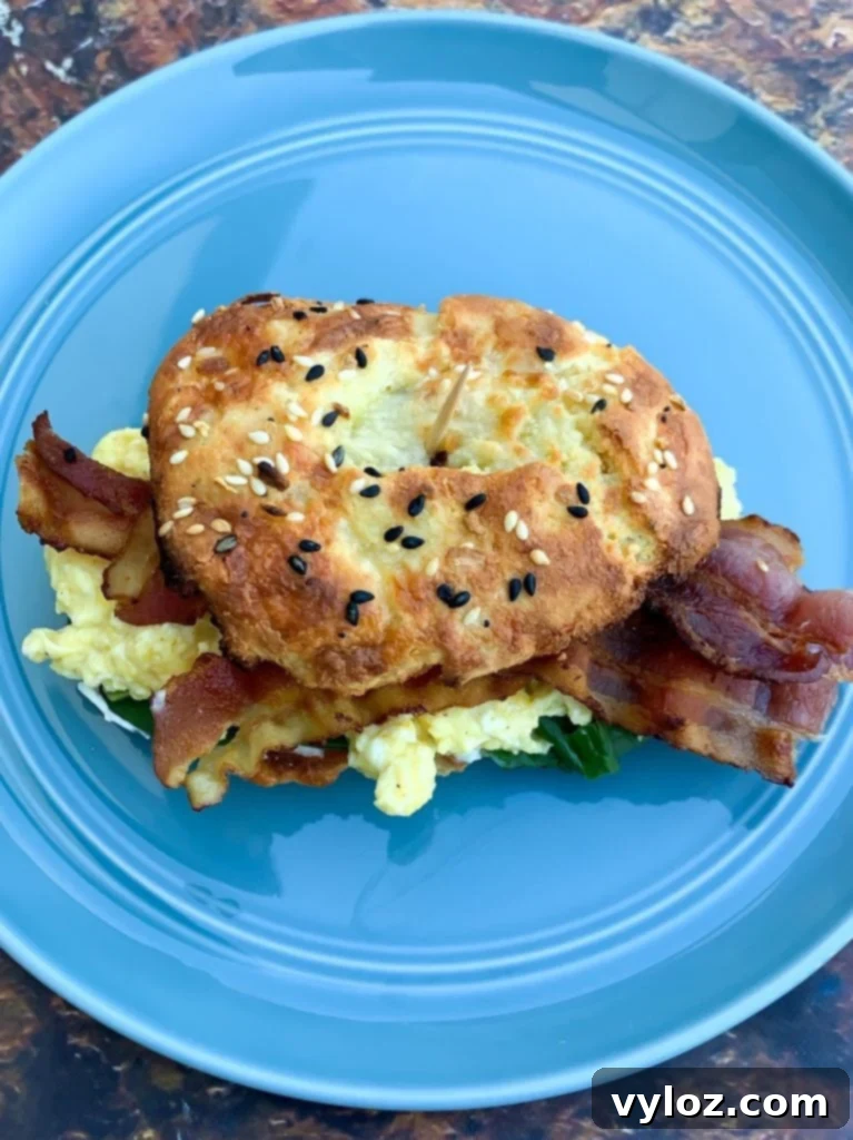 Cooked keto fathead bagel sandwich with bacon and eggs