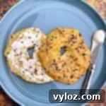 Cooked keto fathead bagels on a blue plate with cream cheese