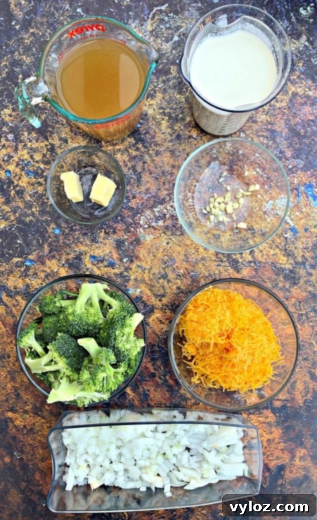 A selection of fresh ingredients including broccoli florets, chopped onions, and spices, ready for making keto low carb instant pot broccoli cheddar soup.
