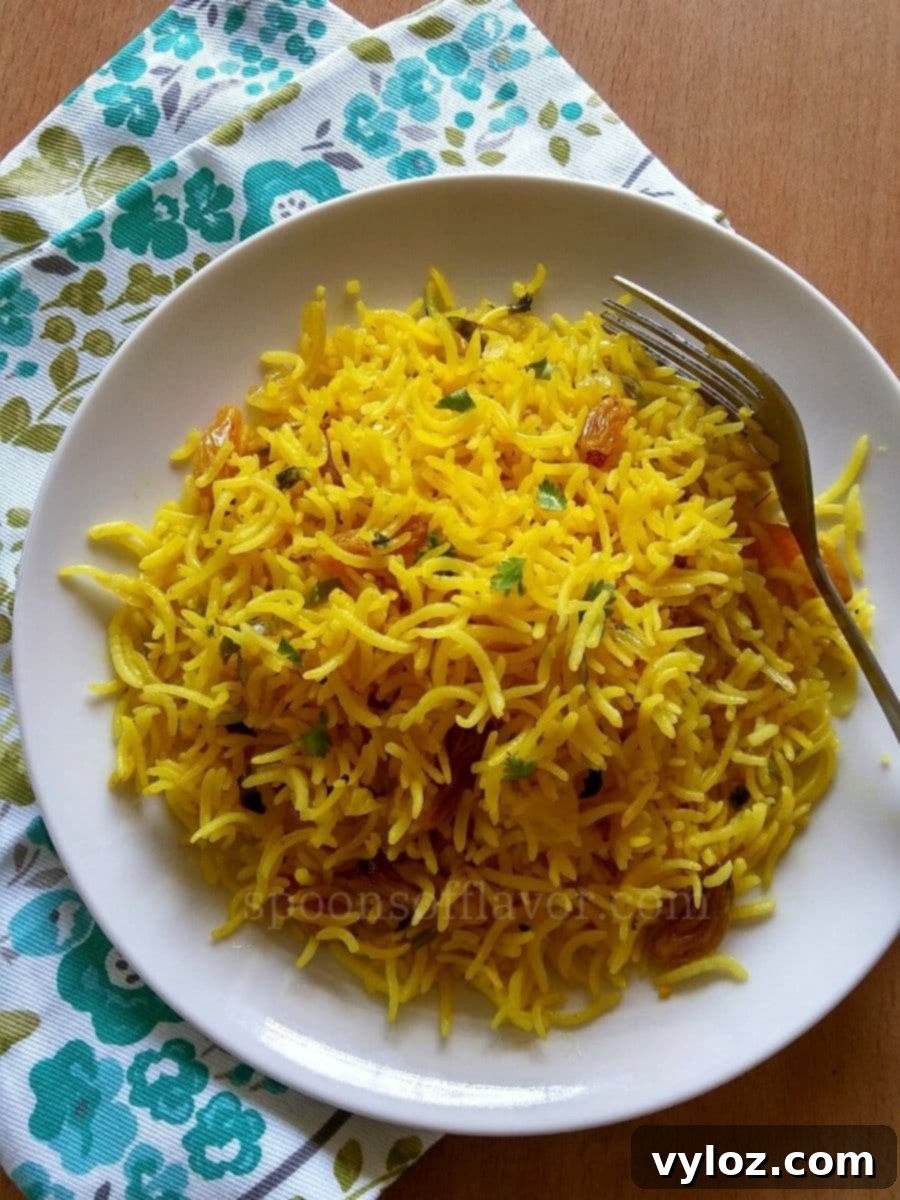 Mediterranean Sunshine Rice 6 Image showing golden yellow rice served on a white plate.