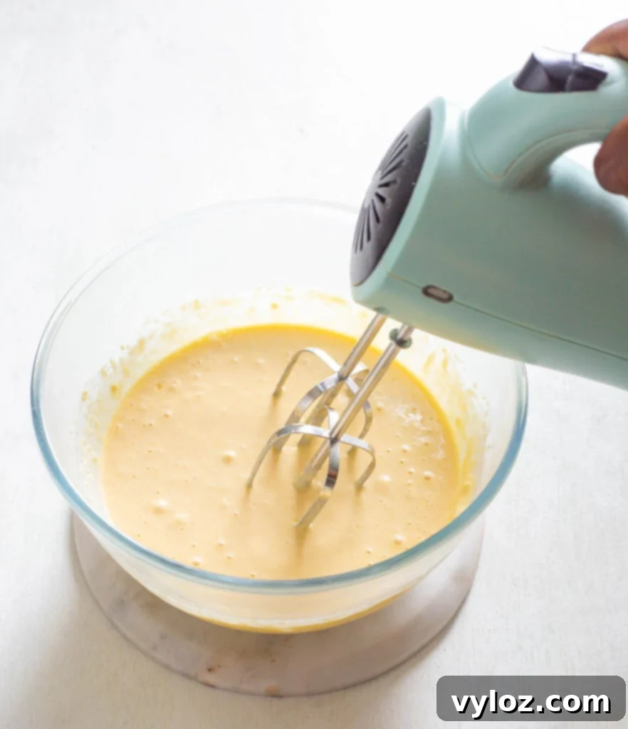 Smooth, well-combined sugar-free cupcake batter resting in a clear glass bowl, showcasing its readiness for baking.