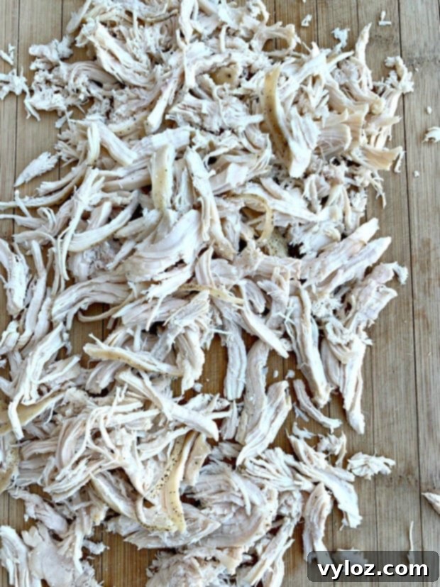 shredded chicken on a cutting board