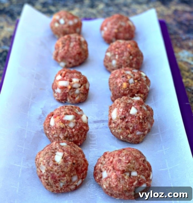 Air Fryer BBQ Beef Meatballs 5 Raw keto low carb meatballs on parchment paper ready for air frying