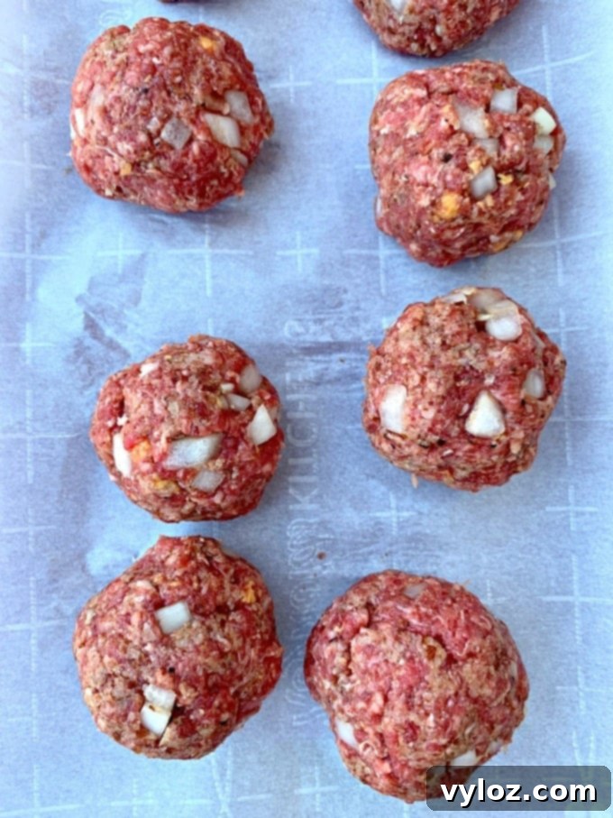 Air Fryer BBQ Beef Meatballs 6 Raw keto low carb meatballs on parchment paper before cooking