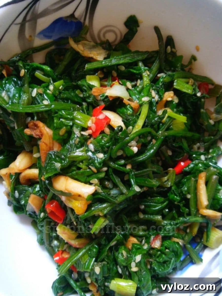 Stir fried spinach served on a white plate