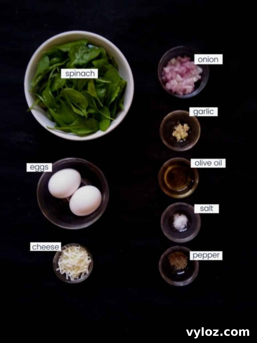 Quick and Delicious Cheesy Spinach Omelet 3 Image showing Spinach omelette ingredients placed on a black background.