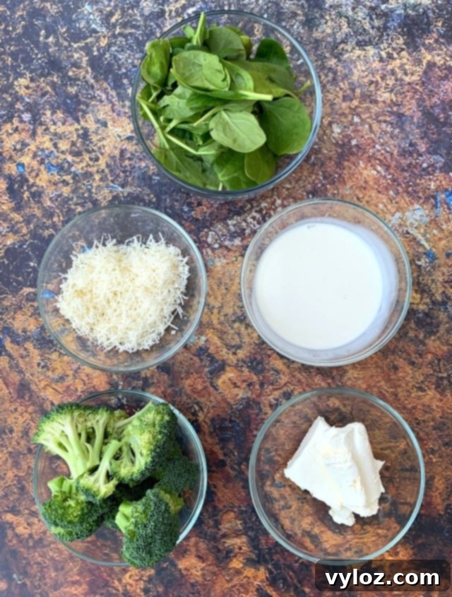 Creamy Keto Chicken Alfredo with Shirataki Fettuccine 4 A vibrant display of fresh ingredients for keto chicken alfredo, including chicken, broccoli, spinach, and heavy cream.