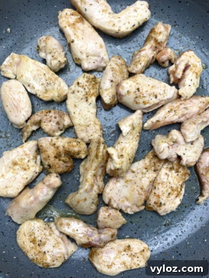 Creamy Keto Chicken Alfredo with Shirataki Fettuccine 9 Perfectly cooked chicken pieces in a skillet, golden brown and ready to be combined with the alfredo sauce.