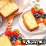 keto pound cake with whipped cream and strawberries on a white plate