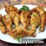 Thumbnail image of air fryer chicken drumsticks on a white plate.