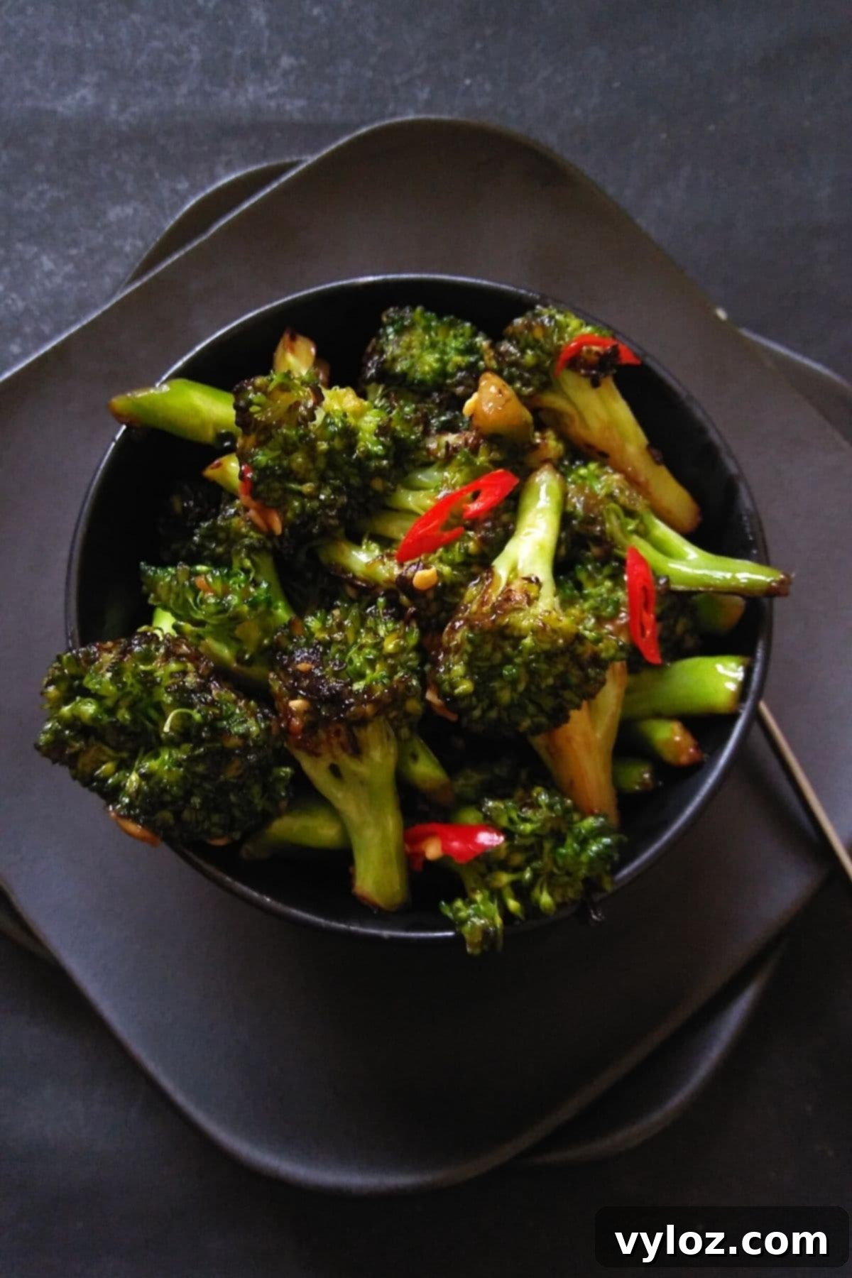 Image showing stir fried broccoli served in a black bowl.