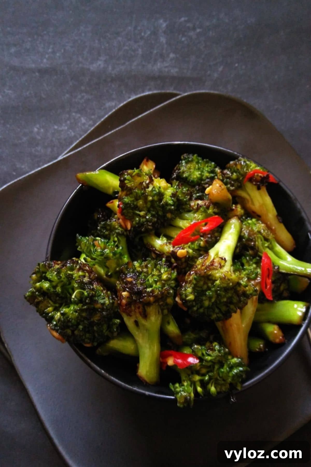 Image showing stir fried broccoli served in a black bowl.