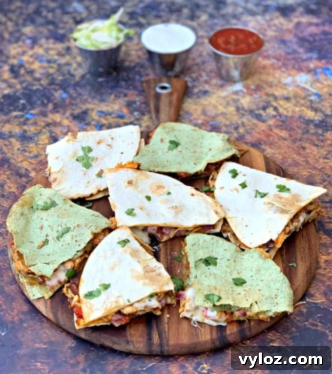 Crispy Air Fryer Chicken Quesadillas on a brown wooden board, garnished and ready to serve