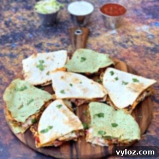 Air fryer chicken quesadillas on a brown board