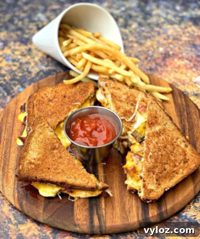 Crispy Air Fryer Grilled Cheese 6 Crispy air fryer bacon grilled cheese sandwiches sliced in half, served with a side of french fries