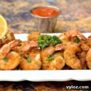Sugar-Free Homemade Keto Cocktail Sauce 9 keto low carb breaded shrimp on a white plate