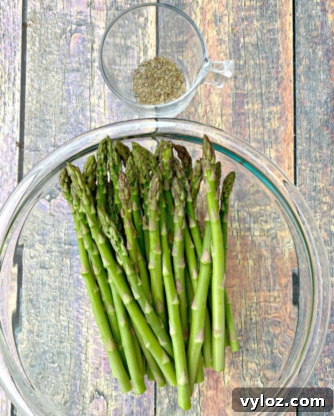 Raw asparagus in a glass bowl, ready for preparation
