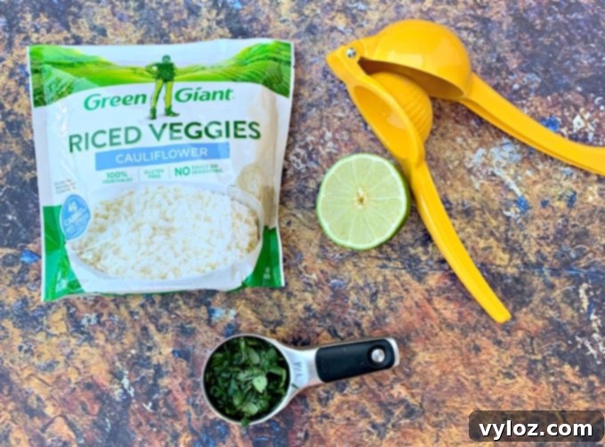 frozen riced cauliflower, fresh lime, and fresh cilantro on flat surface